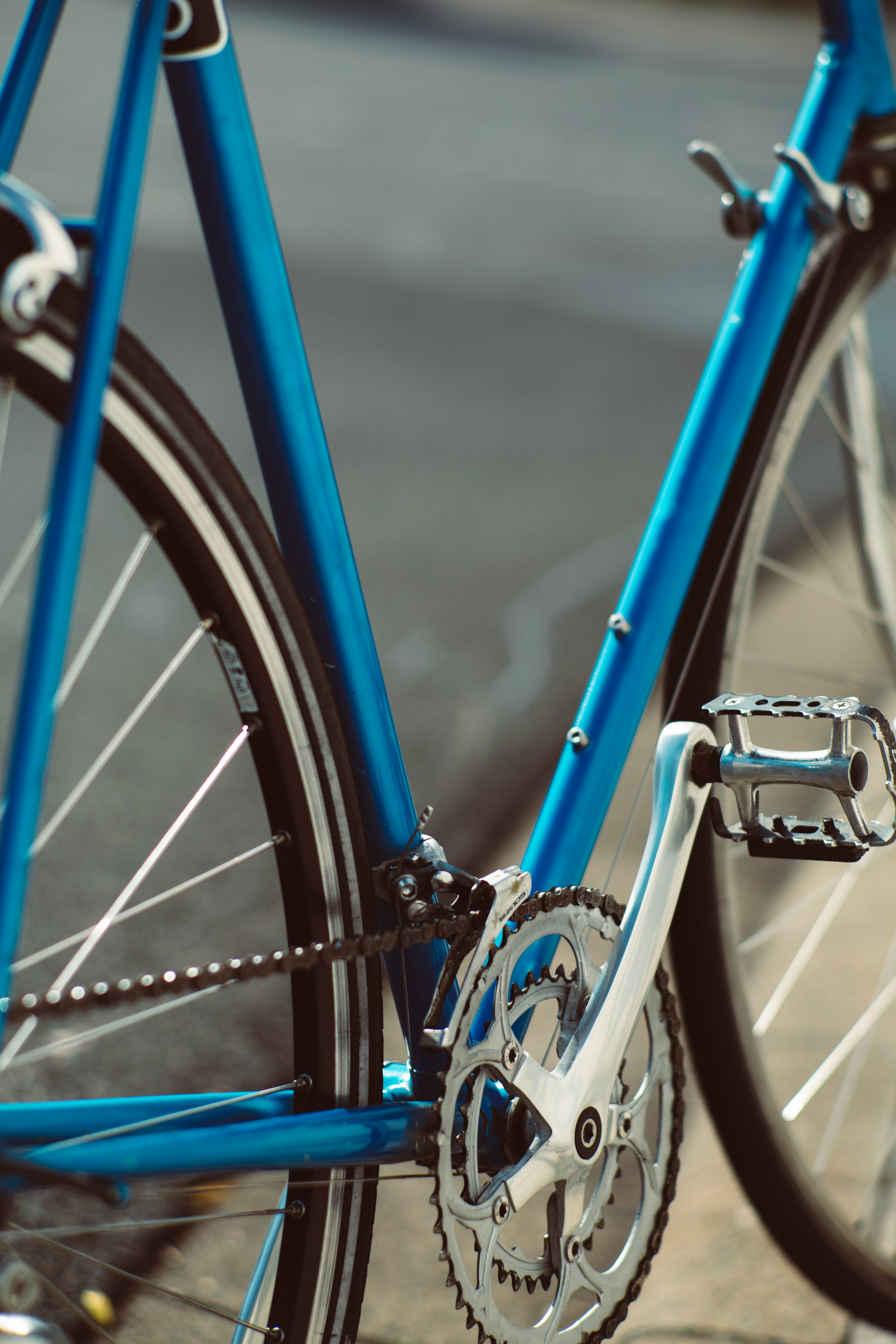 blue and black bicycle in close up photography